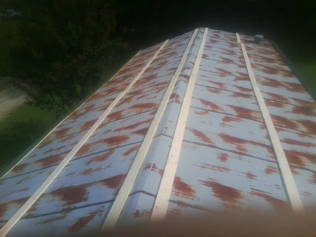 Rusted metal roof panels with new wood purlins before replacement — Storm Damage Roof Repair in New Philadelphia by Roofing Brothers